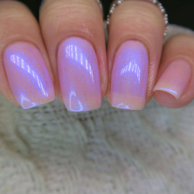 A Whimsical Dream by Dam Nail Polish, sheer pink jelly base with blurple shimmer intensifying toward nail tips, on a light skin tone hand