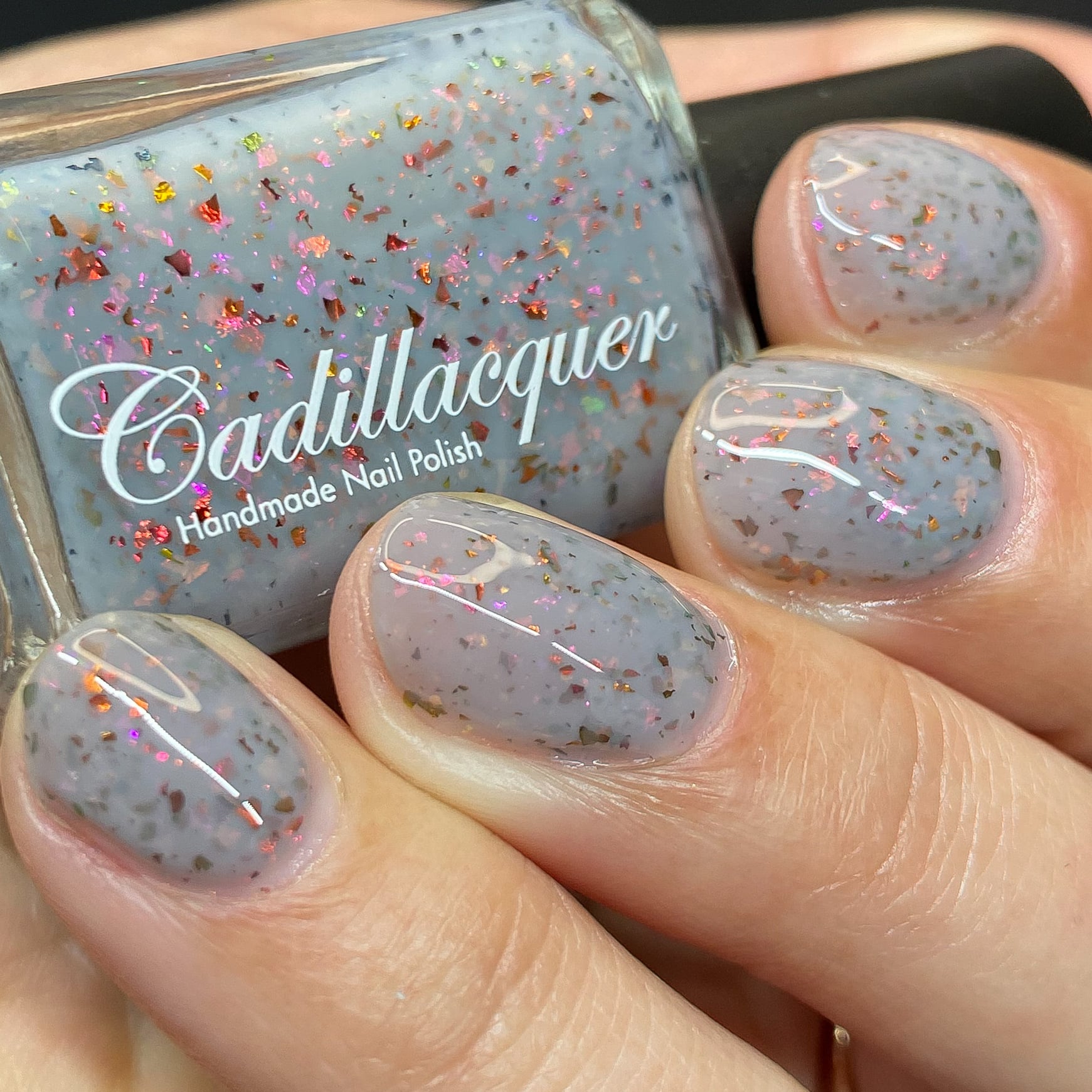 Cadillacquer Daydreaming grey red chameleon iridescent crelly nail polish, swatched on four nails, light skin, studio lighting
