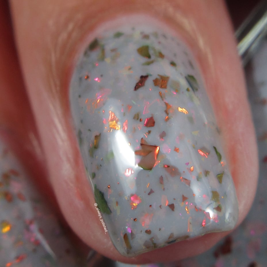 Cadillacquer Daydreaming grey red chameleon iridescent crelly nail polish, macro single-nail swatch, light skin, indoor warm lighting