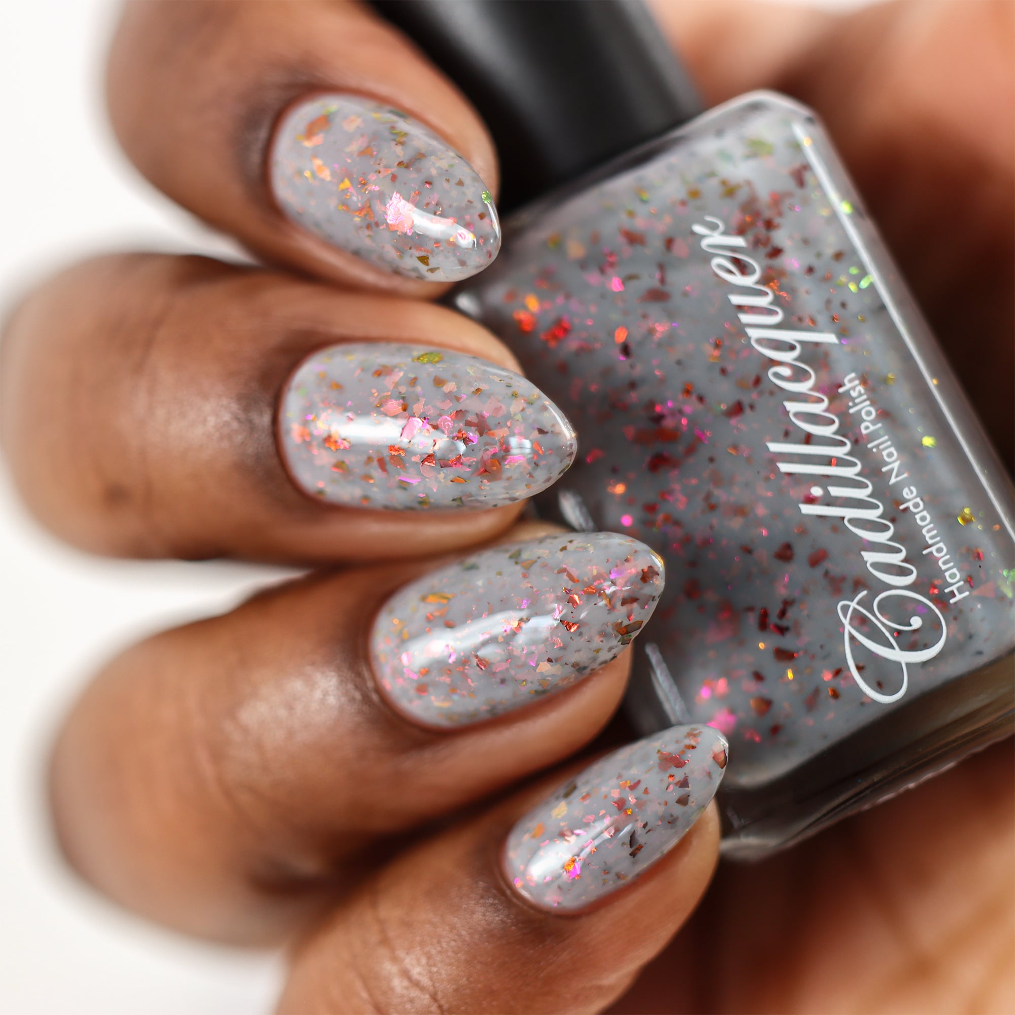 Cadillacquer Daydreaming grey red chameleon iridescent crelly nail polish, swatched on four nails, rich skin, studio lighting