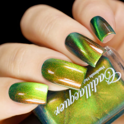 Magnetic multichrome shimmer Cadillacquer nail polish in I Found A Place, swatched on four short natural nails showing deep forest green field regions with bright lime-chartreuse magnetic cat-eye band stripe and copper-to-red-orange aurora shimmer, light skin tone, studio lighting against black background, swatched by @yyulia_m