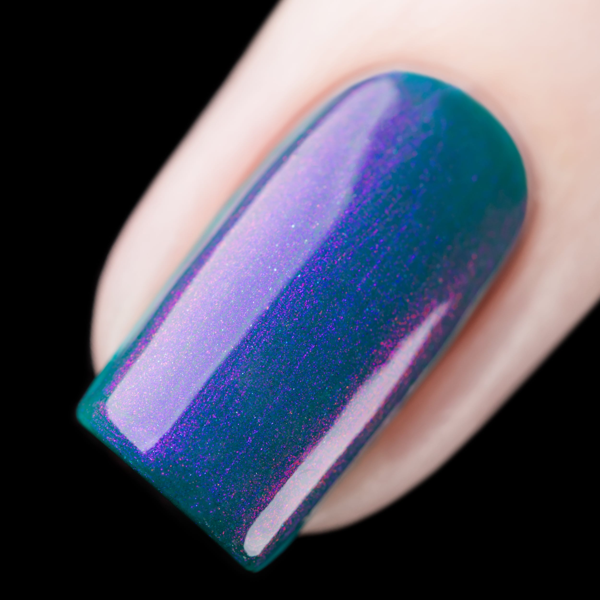 Multichrome shimmer Cadillacquer nail polish in It's All For You, single square nail swatch showing a deep teal green base packed with vivid violet-purple to pink-lavender iridescent shimmer that shifts dramatically across the nail surface, light skin tone, studio lighting, swatched by @rafinails