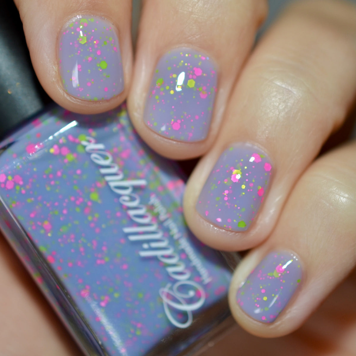 Cadillacquer Magical Creatures nail polish swatched with bottle, lilac crelly and neon green glitter