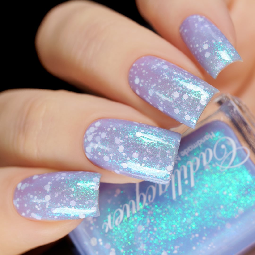 Cadillacquer Spotted Glass Frog light blue jelly nail polish held with bottle
