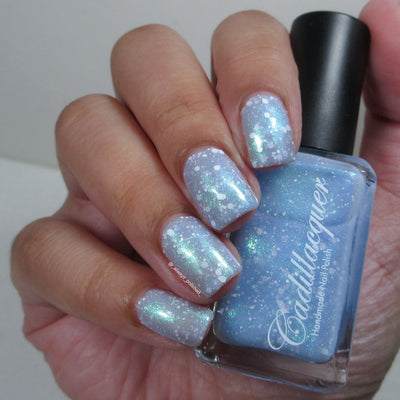 Cadillacquer Spotted Glass Frog nail polish swatched on nails, translucent blue with matte white glitter