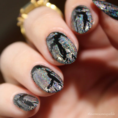 Castle of Glass (Crackle) by Danglefoot Nail Polish, silver holographic crackle topper on a light skin tone hand