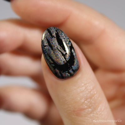 Castle of Glass (Crackle) by Danglefoot Nail Polish, silver holographic crackle topper on a light-medium skin tone hand
