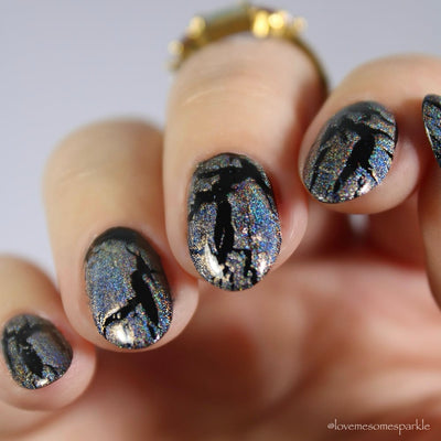 Castle of Glass (Crackle) by Danglefoot Nail Polish, silver holographic crackle topper on a light skin tone hand