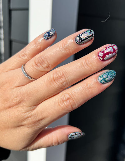 Castle of Glass (Crackle) by Danglefoot Nail Polish, silver holographic crackle topper on a light-medium skin tone hand
