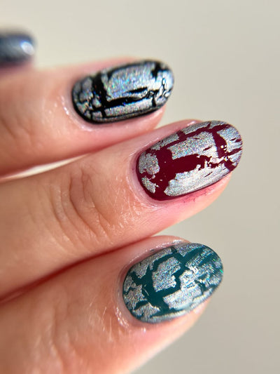Castle of Glass (Crackle) by Danglefoot Nail Polish, silver holographic crackle topper on a light skin tone hand