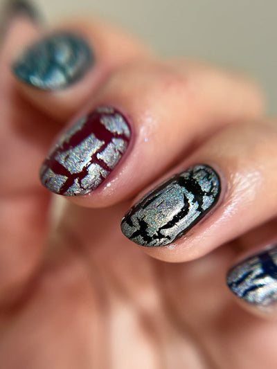Castle of Glass (Crackle) by Danglefoot Nail Polish, silver holographic crackle topper on a light-medium skin tone hand