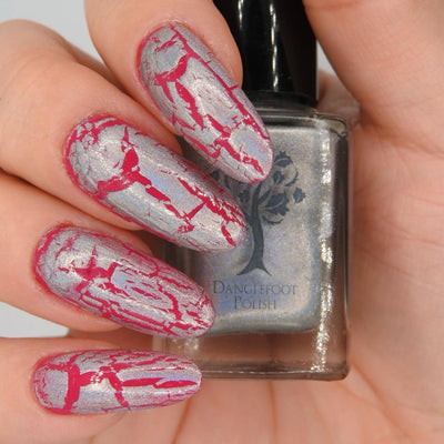Castle of Glass (Crackle) by Danglefoot Nail Polish, silver holographic crackle topper on a light skin tone hand