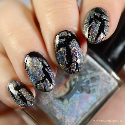 Castle of Glass (Crackle) by Danglefoot Nail Polish, silver holographic crackle topper on a light skin tone hand
