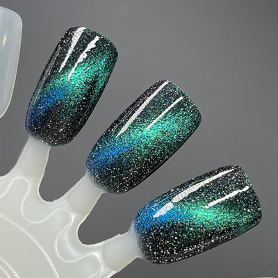 Chinese Zodiac Full Set by Dam Nail Polish, Dog shade, deep black base with vivid emerald-to-blue cat-eye magnetic effect and dense silver reflective glitter, swatch stick
