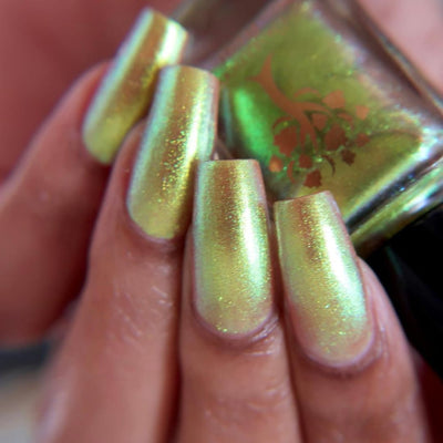 Flame On by Danglefoot Nail Polish, gold-green duochrome shimmer on a light-medium skin tone hand