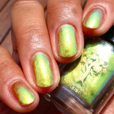 Flame On by Danglefoot Nail Polish, gold-green duochrome shimmer on a light-medium skin tone hand