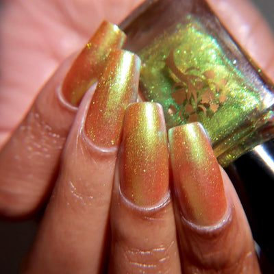 Flame On by Danglefoot Nail Polish, gold-green duochrome shimmer on a light-medium skin tone hand