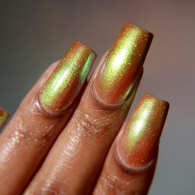 Flame On by Danglefoot Nail Polish, gold-green duochrome shimmer on a medium-deep skin tone hand