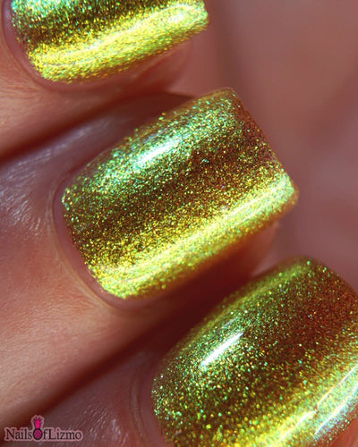 Flame On by Danglefoot Nail Polish, gold-green duochrome shimmer on a light-medium skin tone hand
