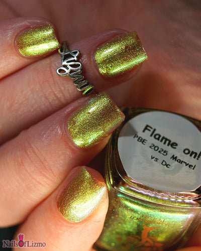 Flame On by Danglefoot Nail Polish, gold-green duochrome shimmer on a light skin tone hand