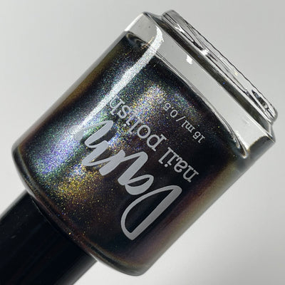 Horse by Dam Nail Polish, multichrome magnetic in darker angle showing deep base with blue-purple and bronze-gold shifts with holographic shimmer, bottle standalone product shot