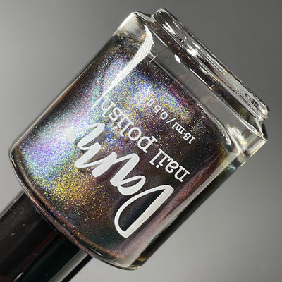 Horse by Dam Nail Polish, multichrome magnetic mid-shift from deep purple-brown base to vivid blue with bronze-gold shimmer, bottle standalone product shot