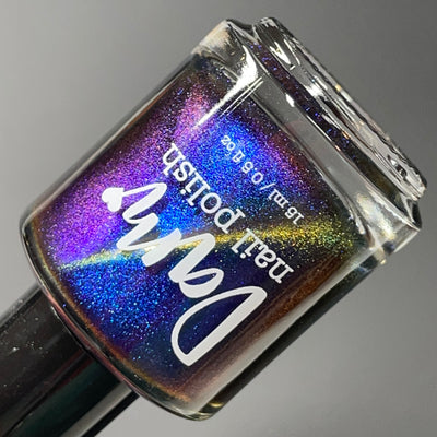 Horse by Dam Nail Polish, blue-to-purple multichrome magnetic showing full spectrum shift from deep electric blue through violet to bronze-gold, bottle standalone product shot