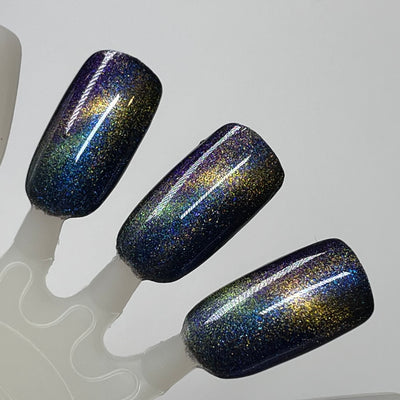 Horse by Dam Nail Polish, blue-to-violet multichrome magnetic with bronze-gold magnetic streak and dense holographic microflakes, fanned swatch stick
