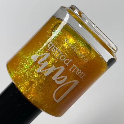 Monkey by Dam Nail Polish, deep golden amber-yellow with yellow and green colour-shifting shimmer, bottle standalone product shot