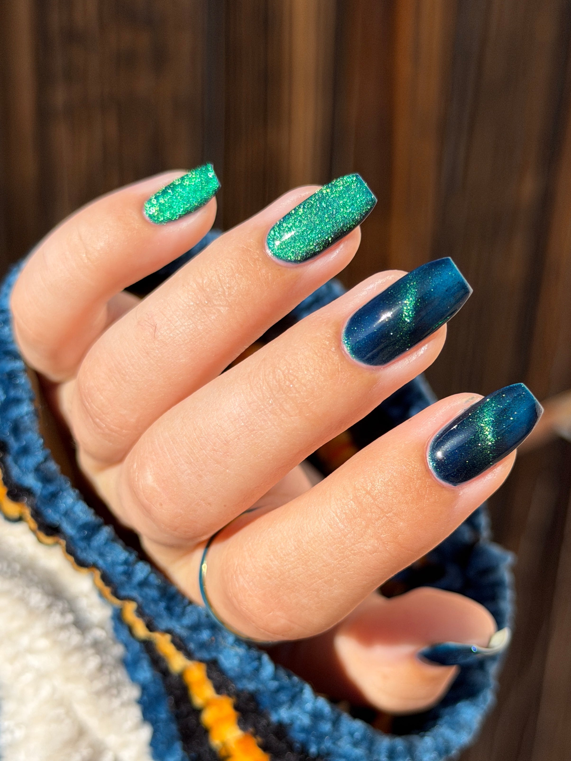 Do-Nuts by Glitch Lacquer, deep blue jelly, green-to-teal-to-blue magnetic, on light-medium skin tone square nails