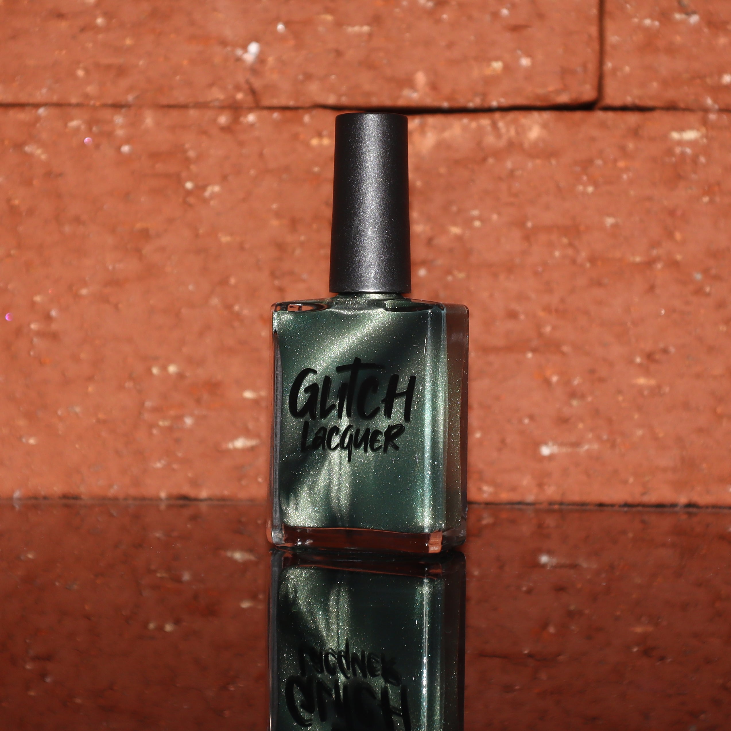 AUREA by Glitch Lacquer, blackened green base with greenish-gold fine-particle magnetic, bottle