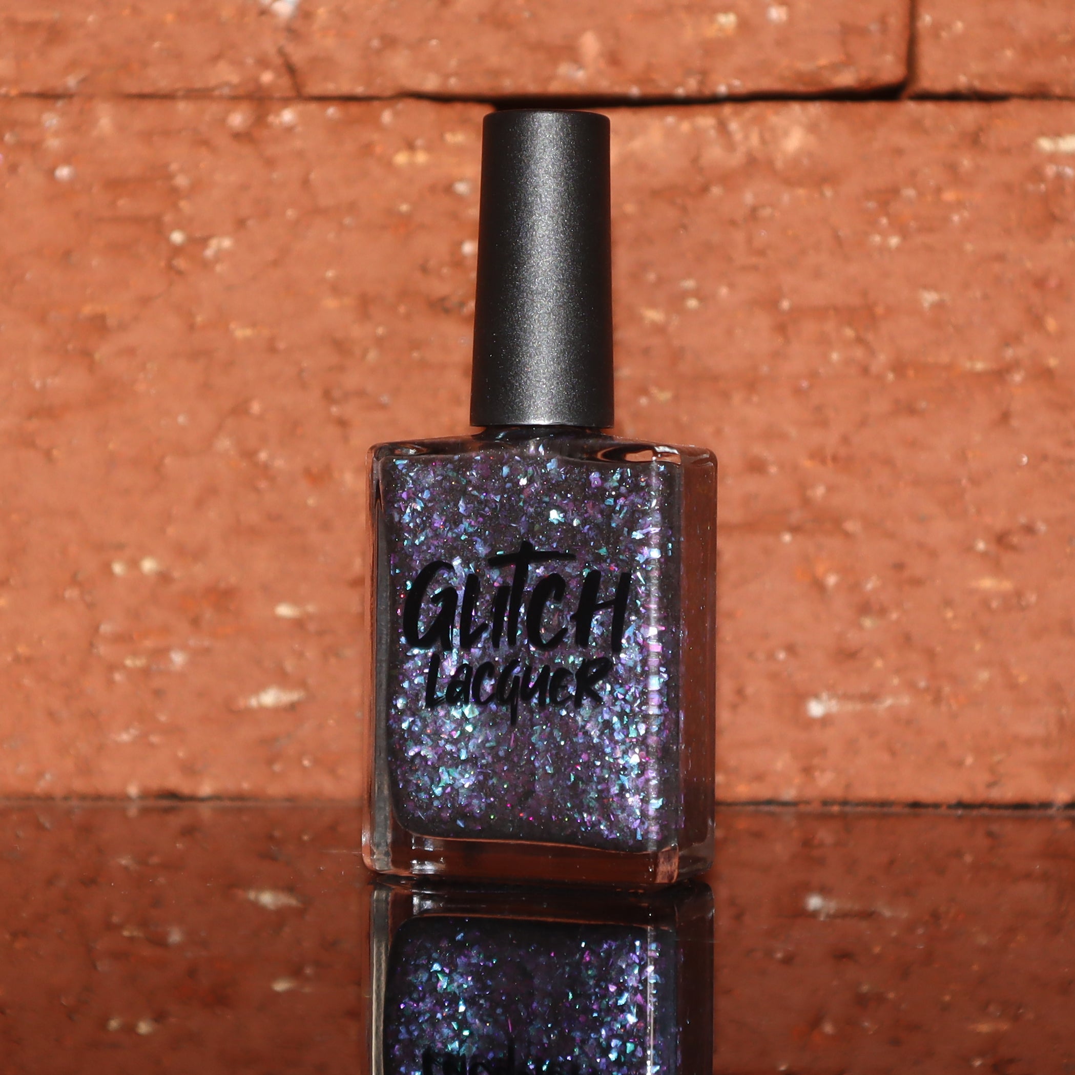 AVEN by Glitch Lacquer, soft black base with iridescent purple flakes and black holo micro-glitter, bottle
