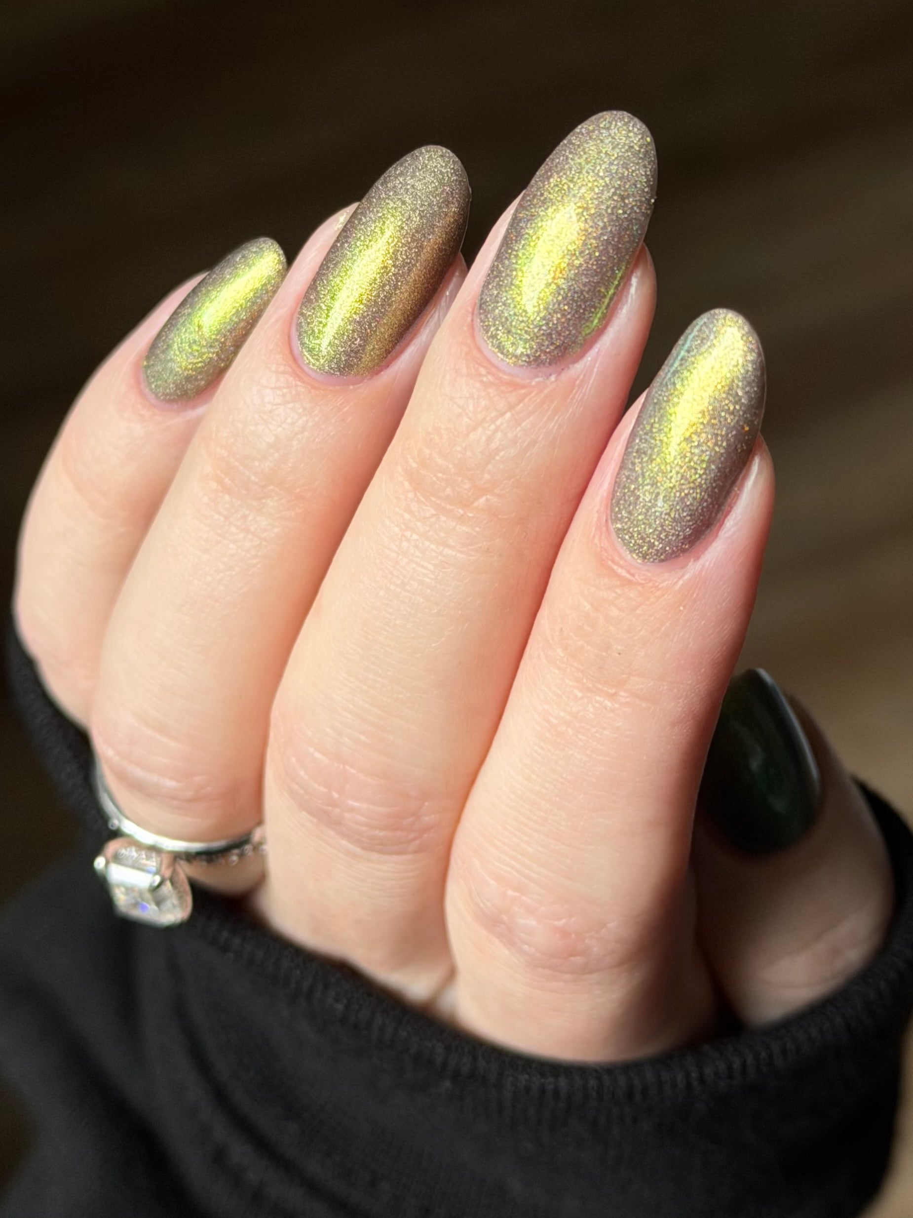 Safe House Glow by Glitch Lacquer, grey base, gold-to-teal multichrome shift, holo shimmer, on light skin tone almond nails