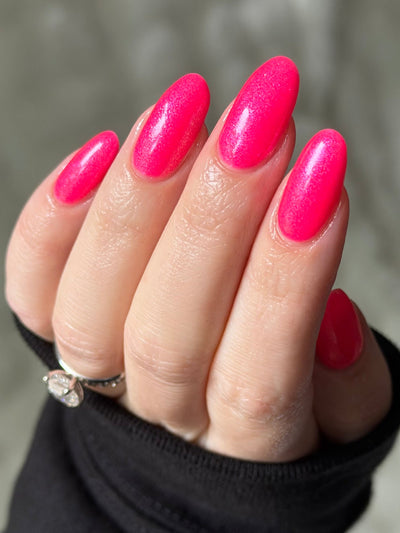 ACT UP by Glitch Lacquer, neon pink crelly with cool-toned pink sparkle, on light skin tone almond nails