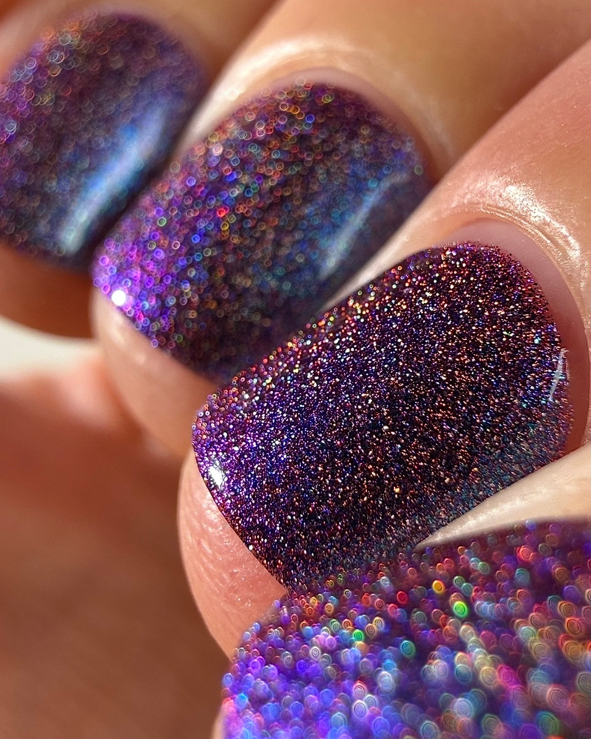 Bi Panic by Glitch Lacquer, magenta jelly, blue-to-purple glow, holographic rainbow scatter, on light-medium skin tone nails