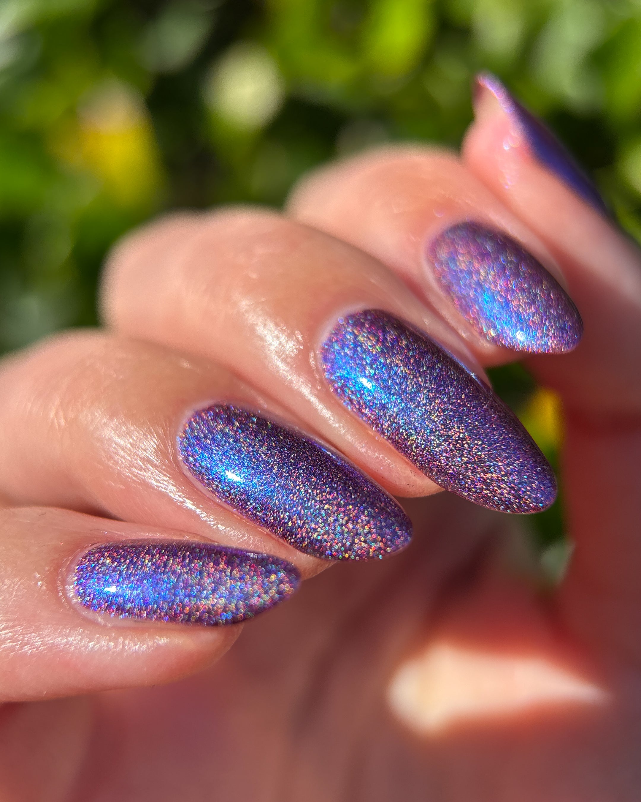 Bi Panic by Glitch Lacquer, magenta jelly, blue-to-purple glow, linear holographic, on light skin tone almond nails