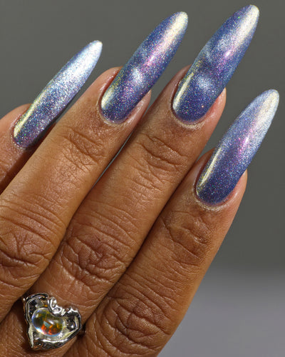 Protect the Dolls by Glitch Lacquer, blue jelly, silver magnetic cat-eye, color-shift shimmer, on medium-deep skin tone nails