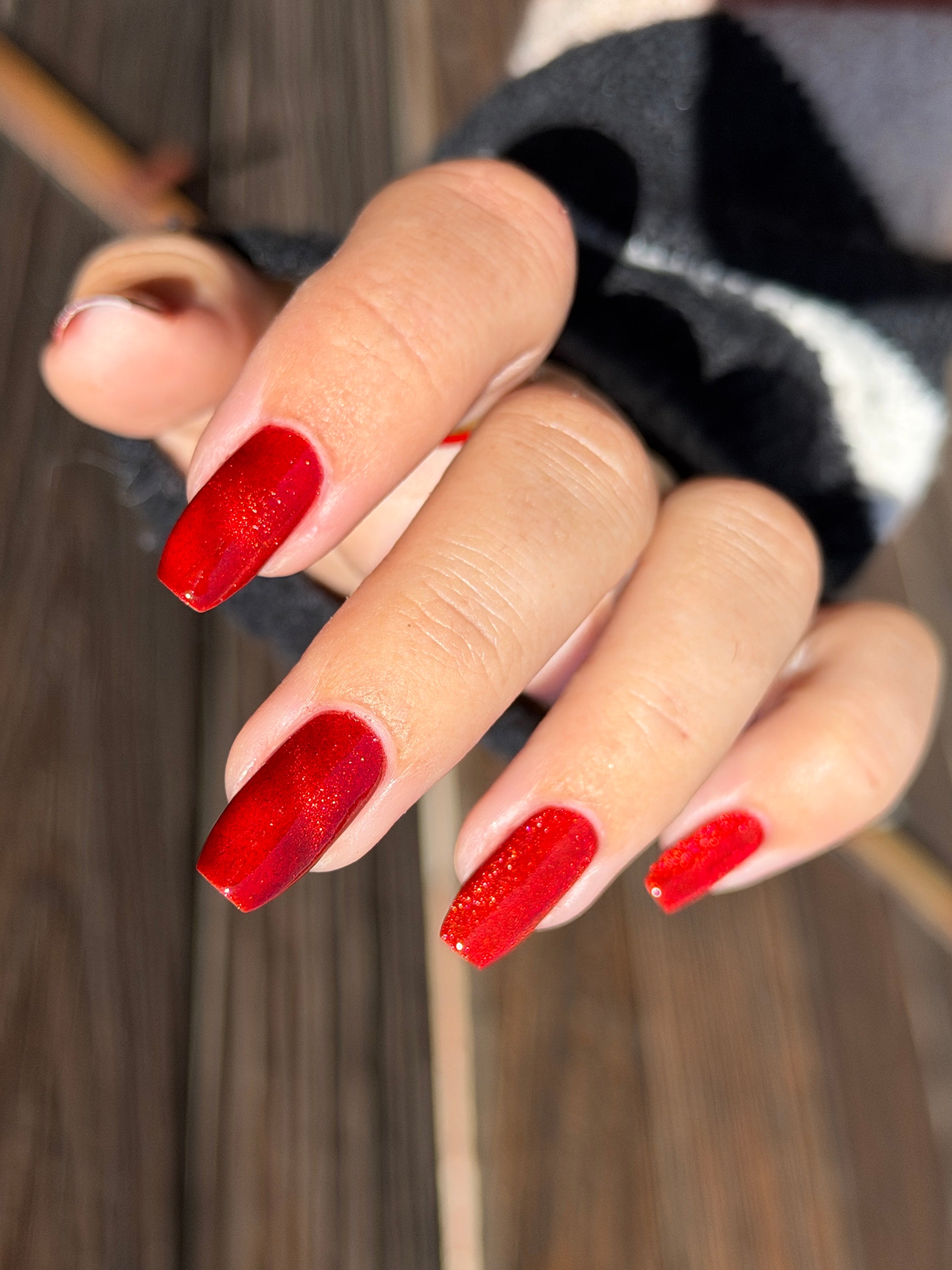 Stonewall by Glitch Lacquer, brick red jelly with bright red magnetic shift, on light skin tone coffin nails
