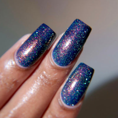 Mr Luthoooor by Danglefoot Nail Polish, blue-green multichrome reflective shimmer glitter on a light-medium skin tone hand