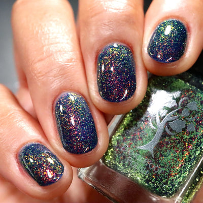 Mr Luthoooor by Danglefoot Nail Polish, blue-green multichrome reflective shimmer glitter on a light-medium skin tone hand