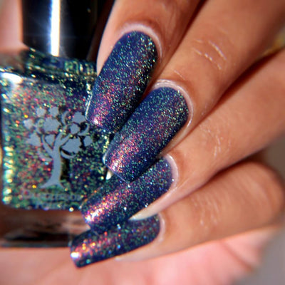 Mr Luthoooor by Danglefoot Nail Polish, blue-green multichrome reflective shimmer glitter on a light-medium skin tone hand