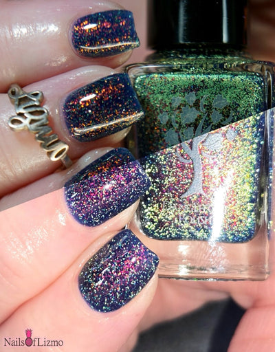 Mr Luthoooor by Danglefoot Nail Polish, blue-green multichrome reflective shimmer glitter on a light-medium skin tone hand