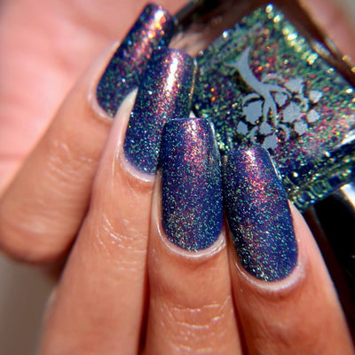 Mr Luthoooor by Danglefoot Nail Polish, blue-green multichrome reflective shimmer glitter on a light skin tone hand