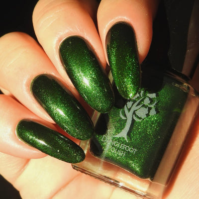 New Divide by Danglefoot Nail Polish, green shimmer jelly magnetic on a light skin tone hand
