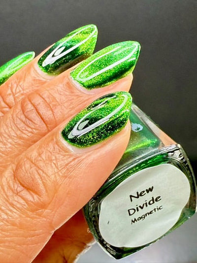 New Divide by Danglefoot Nail Polish, green shimmer jelly magnetic on a light-medium skin tone hand