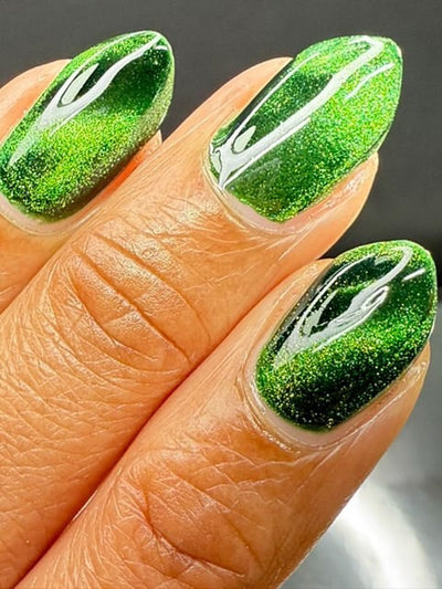 New Divide by Danglefoot Nail Polish, green shimmer jelly magnetic on a light-medium skin tone hand