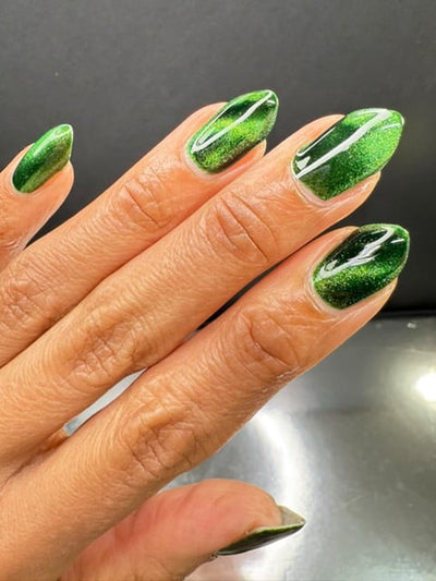 New Divide by Danglefoot Nail Polish, green shimmer jelly magnetic on a light-medium skin tone hand