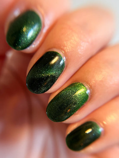 New Divide by Danglefoot Nail Polish, green shimmer jelly magnetic on a light skin tone hand