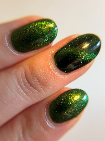 New Divide by Danglefoot Nail Polish, green shimmer jelly magnetic on a light skin tone hand