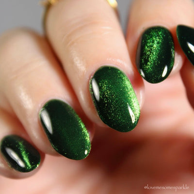 New Divide by Danglefoot Nail Polish, green shimmer jelly magnetic on a light skin tone hand